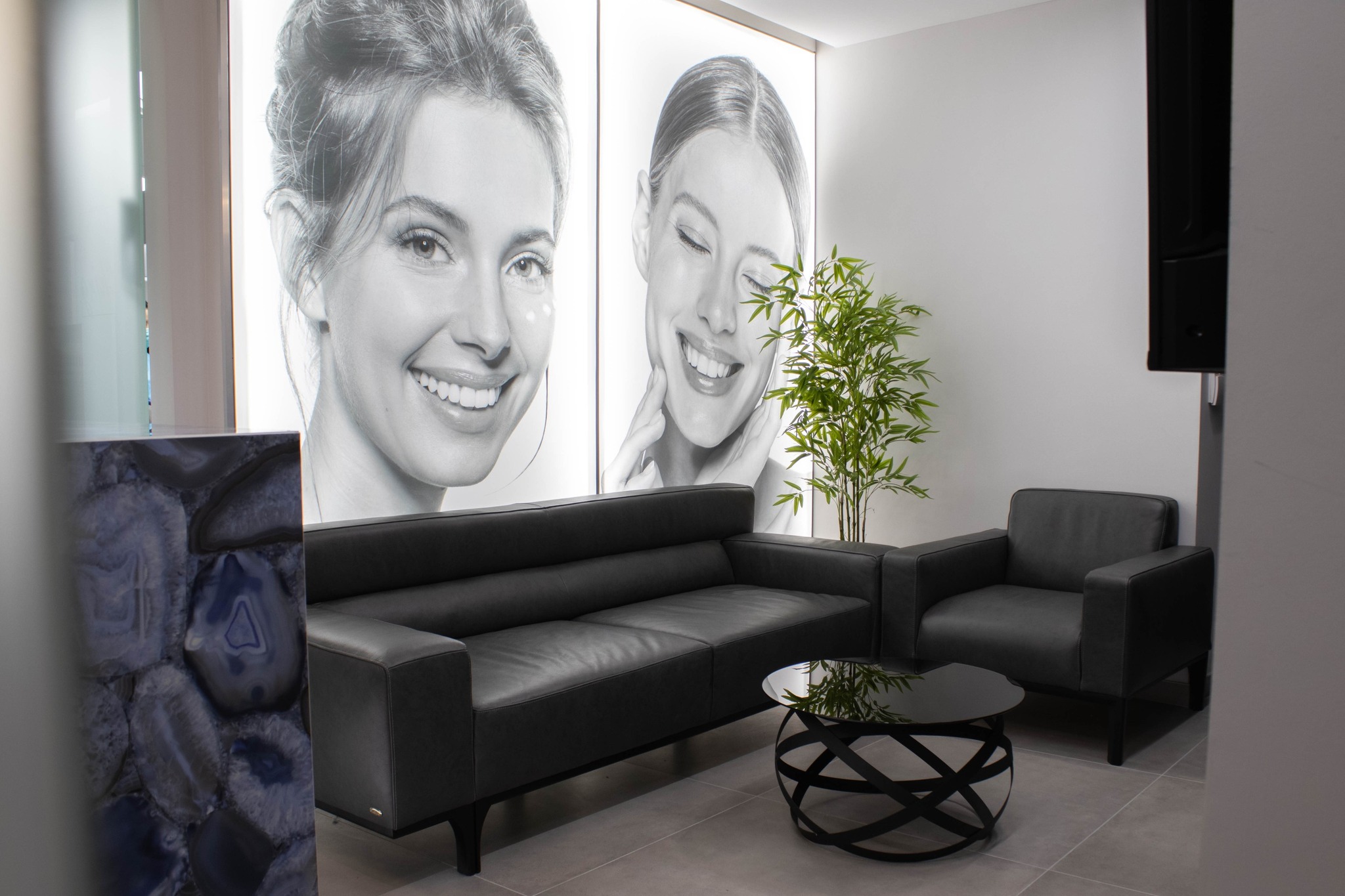 Comfortable waiting area with modern seating and patient portraits