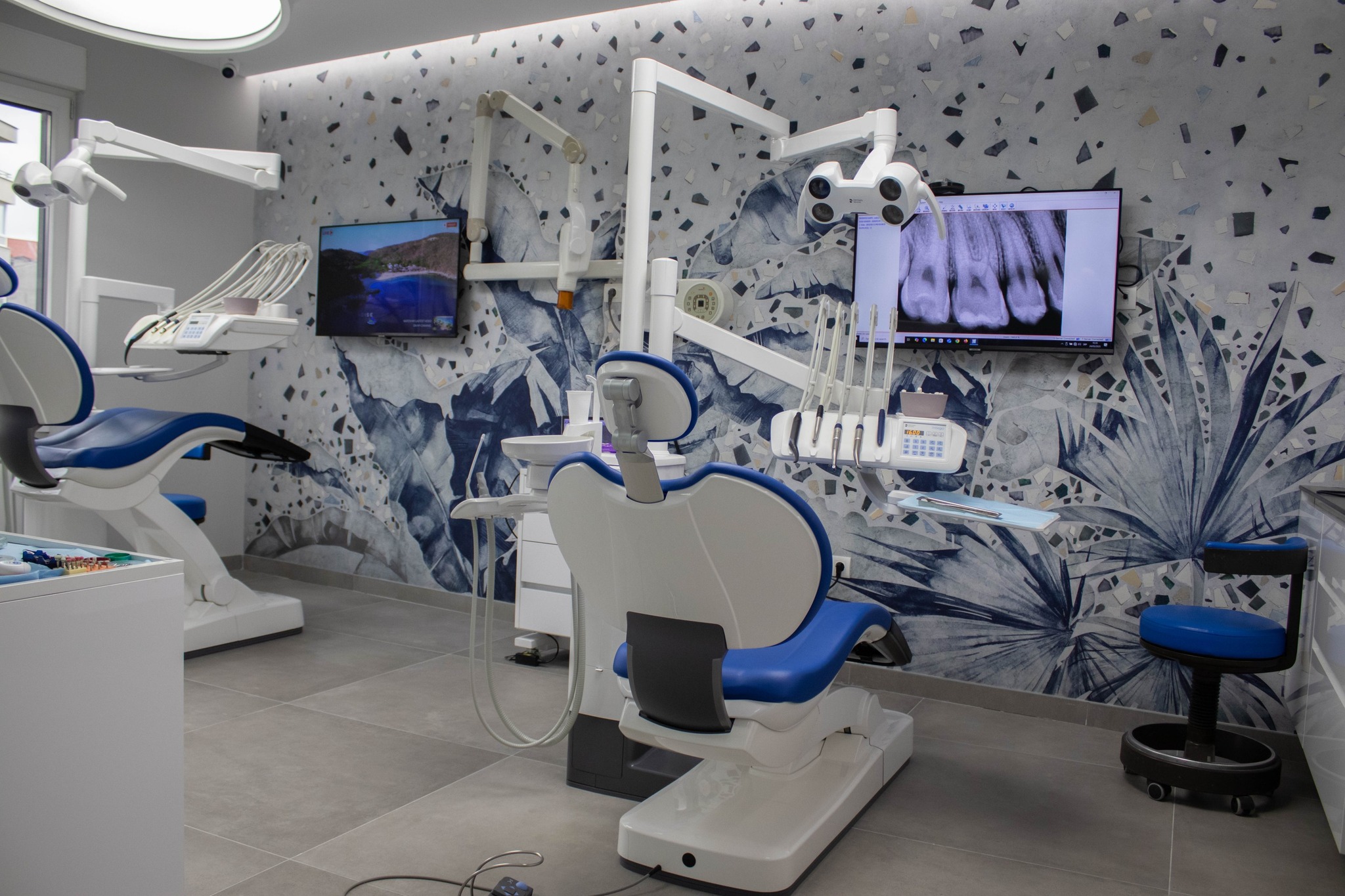 Dental treatment room with multiple chairs and high-tech setup