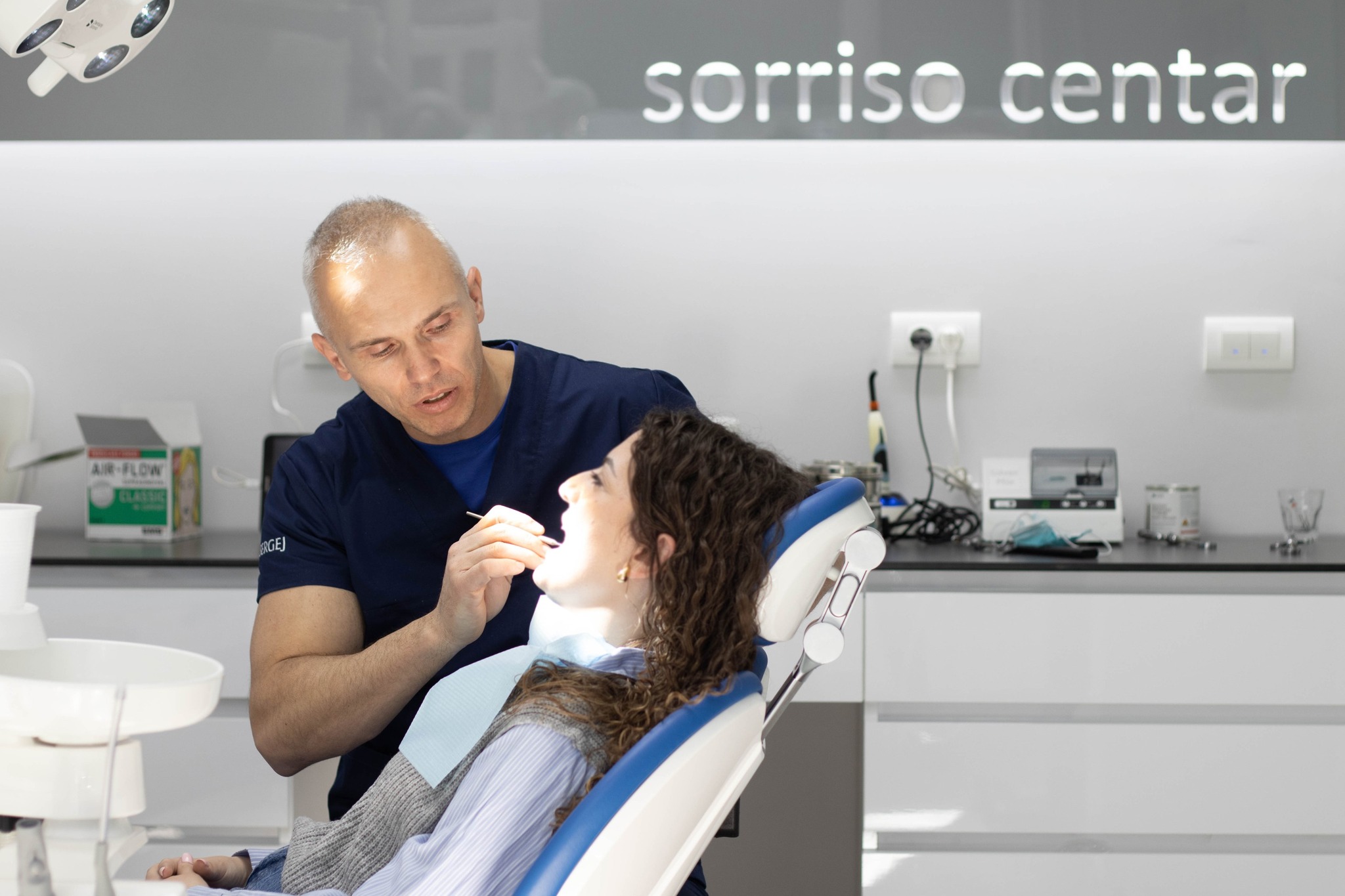 Dentist treating patient in modern clinic